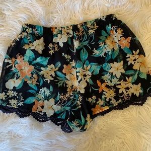 Navy blue and floral shorts with lace detail.